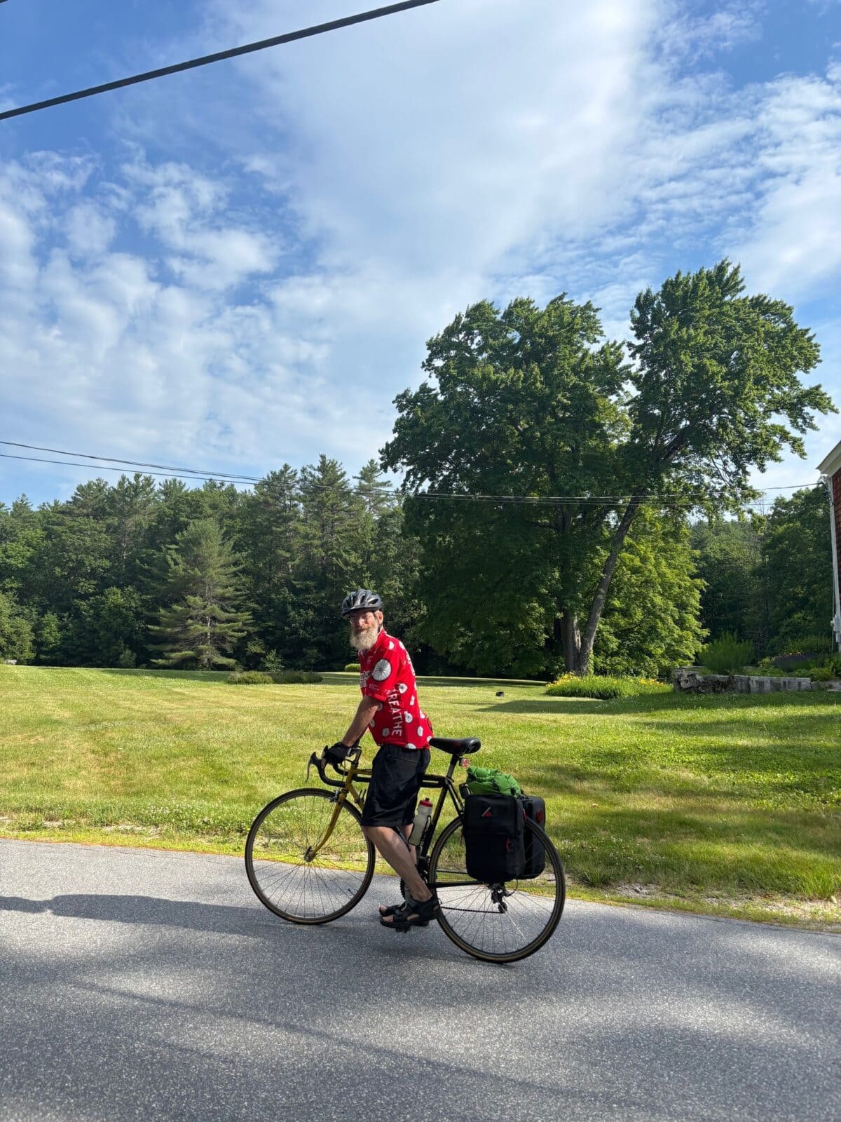 A photo of Andy Davis on his bicycle on a country road.