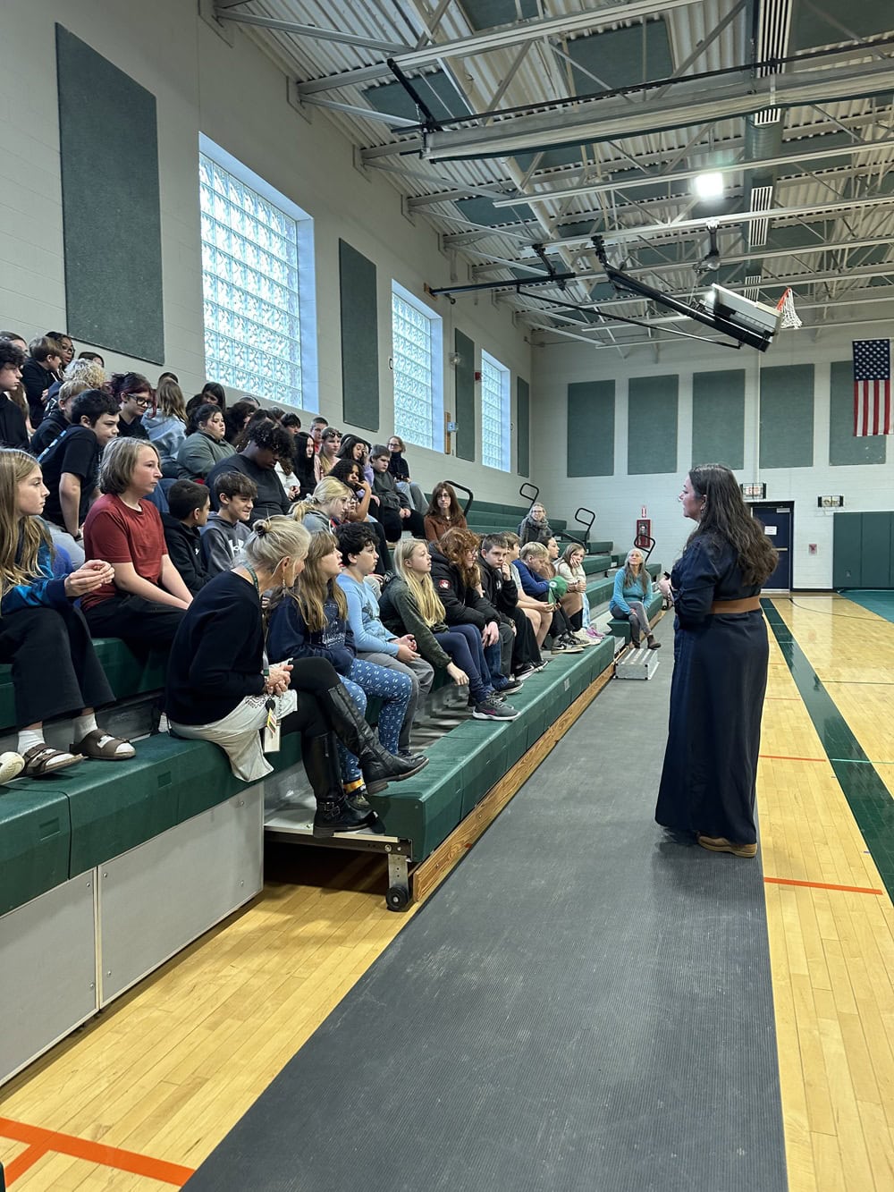 Photo of children's author Kari Allen talking to students at the K.A. Brett School