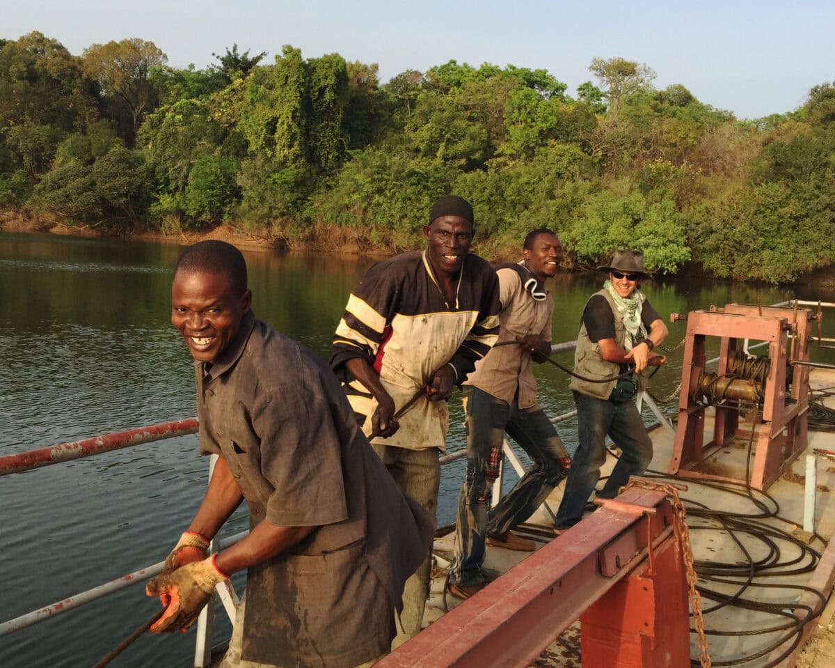 Photo of four men, including Dave Kobrenski, in a boat in Niger, West Africa
