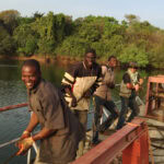 Photo of four men in a boat in Niger, West Africa