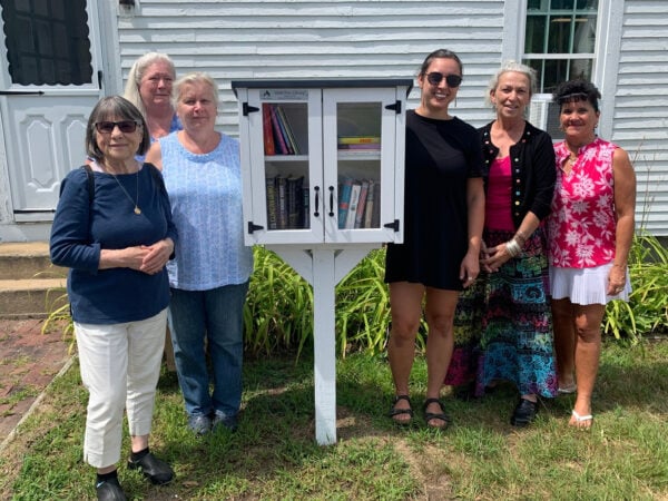 photo of six people standing by a Little Free Library in South Tamworth