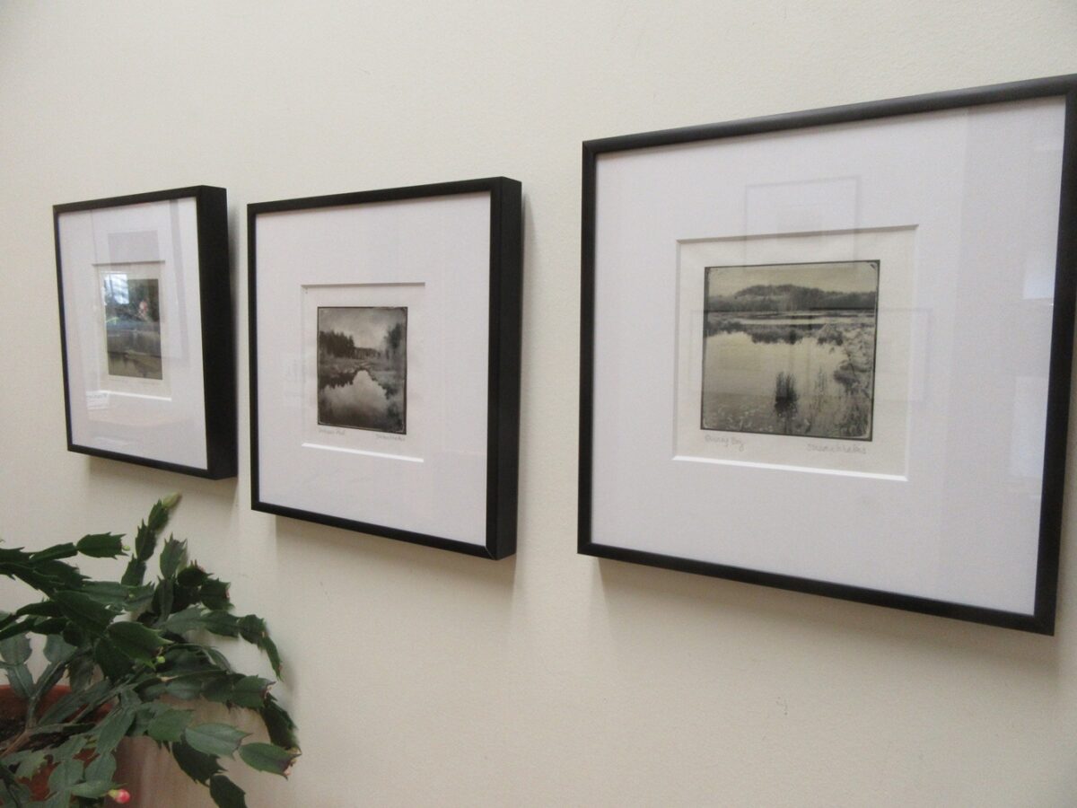 Photo of three framed photographs hanging on a wall