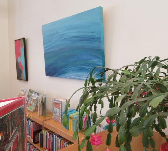 Photo of paintings by artist Margaret Dries hung on the wall at Cook Memorial Library.