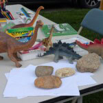 photo of art supplies on a table with toy dinosaurs