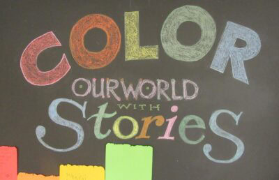 Photo of the "Color Our World with Stories" door display at the Cook Memorial Library, summer 2025.